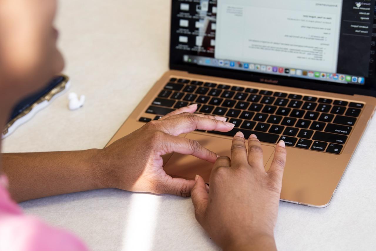 A person typing on a laptop computer.